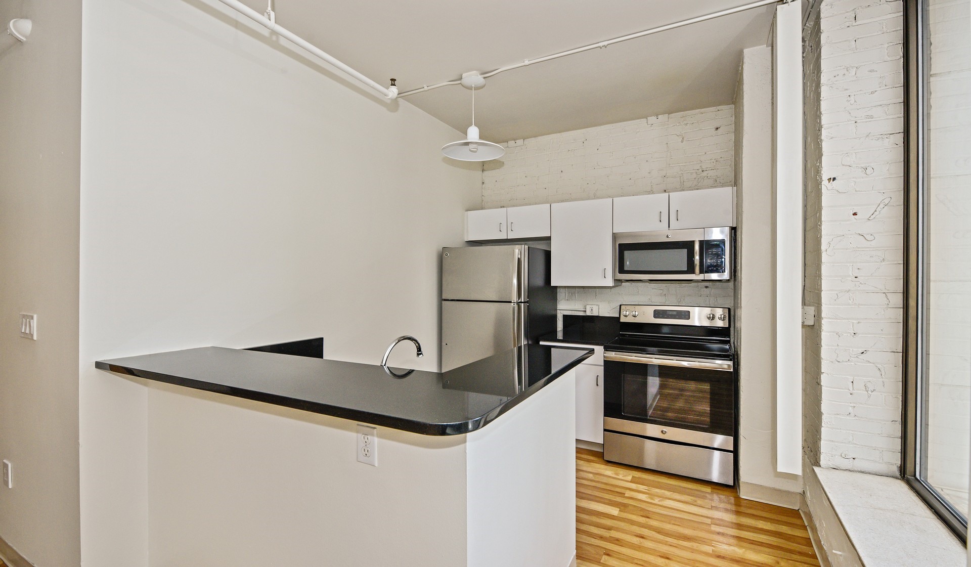 Kitchen provides granite countertop breakfast bar and stainless steel appliances